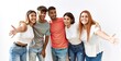 © Krakenimages.com - Group of young friends standing together over isolated background looking at the camera smiling with open arms for hug. cheerful expression embracing happiness.