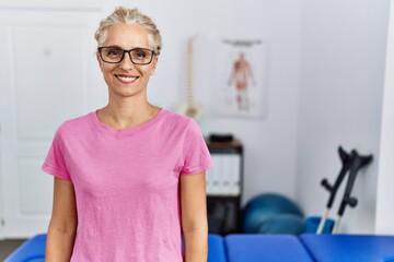 Sticker - Middle age blonde woman at pain recovery clinic with a happy and cool smile on face. lucky person.