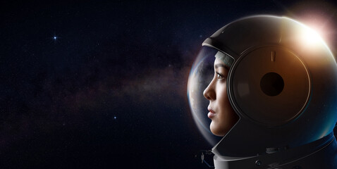 head shot of attractive female astronaut wearing a helmet in outer space looking at planet earth. 3d