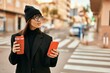© Krakenimages.com - Young hispanic woman using smartphone drinking coffee at the city.