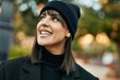 © Krakenimages.com - Young hispanic woman smiling happy standing at the park.