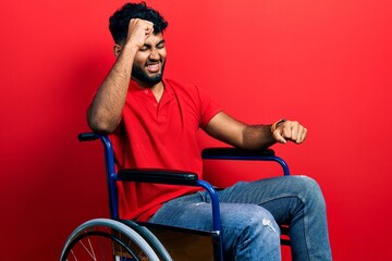 Canvas Print - Arab man with beard sitting on wheelchair dancing happy and cheerful, smiling moving casual and confident listening to music