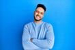 © Krakenimages.com - Young arab man wearing casual clothes happy face smiling with crossed arms looking at the camera. positive person.