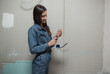 © kalinichenkod - young beautiful woman makes repairs in the apartment. the girl makes repairs at home on her own paints the walls