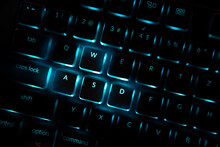 Red Color Backlighted Computer Keyboard. Close-up Of Highlighted Default Keys In Games Associated With Movements.