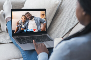 Wall Mural - Virtual Meeting. Black lady having video call with her family on laptop