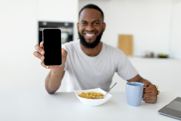Man showing white empty smartphone screen close to camera