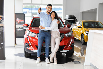 Happpy beautiful muslim family buying new car in salon