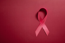 Red Ribbon Symbol Of World Aids Day On Red Background Copy Space