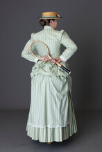 A Victorian Woman Wearing A Tennis Ensemble
