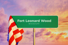 Fort Leonard Wood - Missouri/USA. Road Or City Sign. Flag Of The United States. Sunset Sky.