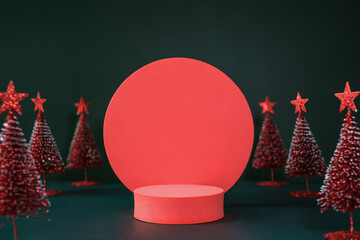 Poster - christmas tree red color with star pine tree group on green background with space