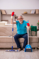 Old man cleaning the house