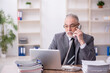 © Elnur - Old male employee working in the office