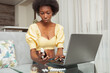 © Valeriia - African American black woman is looking instructions for medicine on Internet, home delivery medicines, online shopping.