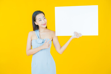 Wall Mural - Portrait beautiful young asian woman with empty white billboard