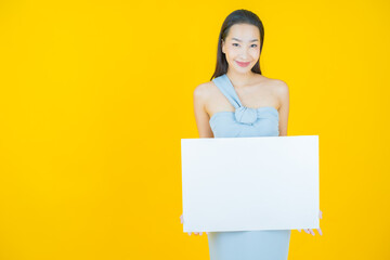 Wall Mural - Portrait beautiful young asian woman with empty white billboard