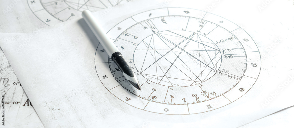 Astrology. Astrologer calculates a natal chart and makes a forecast of fate. Astrological forecast, mysticism, science. Astrological background.