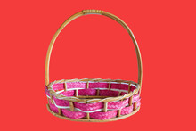 Wicker Basket With Pink Ribbon On Table.