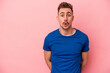 © Asier - Young caucasian man isolated on pink background being shocked because of something she has seen.