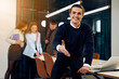 © JJ Studio - Happy office worker reaches his handshake to camera.