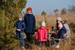 © AS Photo Family - Cheerful mother with kids at a picnic. Family on vacation with fruits outdoor.