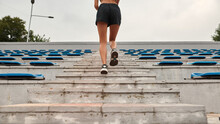 Partial Of Sports Woman Run On Stairs Of Stadium