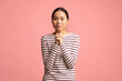 © Prostock-studio - Please. Young asian female begging with clasped hands and looking at camera