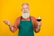 © deagreez - Photo of mature man hold wine glass hospitality service staff cafe owner isolated over yellow color background