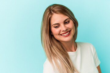 Wall Mural - Young russian woman isolated on blue background