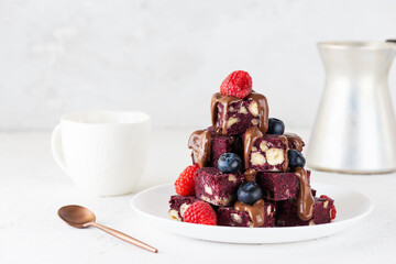 Brownie with beets, hazelnuts, chocolate, raspberries and blueberries and a cup of coffee. Sugar, gluten, lactose free, vegan, no bake, healthy food.