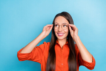 Sticker - Photo of pretty dreamy mature lady dressed red shirt arms glasses smiling looking empty space isolated blue color background