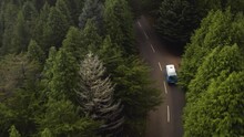 Aerial Follows A VW-Camper Van That Drives Into The Forest And Disappears In The Fog. Madeira, Portugal