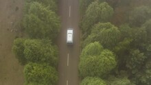 Bird View From An Aerial Showing A Camper Van Driving On A Foggy Day On Madeira, Portugal
