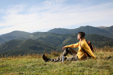 Poster - Tourist with thermos and backpack enjoying beautiful mountain landscape