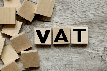 VAT. text on wooden blocks on a wooden background