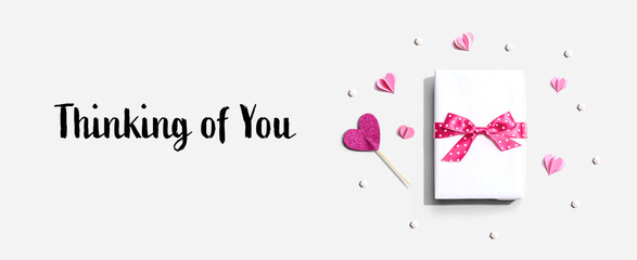 Wall Mural - Thinking of you message with a gift box and paper hearts