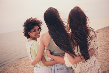 Sticker - Photo of pretty charming young tree girlfriends wear casual clothes smiling embracing outside countryside