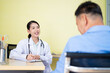 © SKW - Asian female doctor talking to an elderly woman To maintain health with a smile, the concept is to take care of health, elderly patients, teenage doctors.