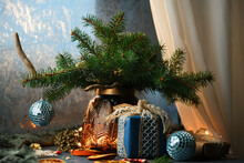 Christmas Cosy Home. Christmas Still Life With Christmas Tree Branches In Vase And Gift Boxes Near Icy Window. 
