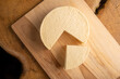 © Milton Buzon - Semi-cured cheese from Brazil, beautiful Brazilian cheese arranged on light rustic wood, selective focus.