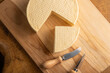 © Milton Buzon - Semi-cured cheese from Brazil, beautiful Brazilian cheeses and cutting accessories arranged on light rustic wood, selective focus.