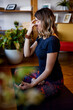 © chika_milan - A yogi woman is sitting on a yoga mat in the lotus position and doing breathing exercises.