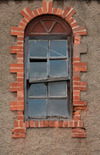 Old, Tumbledown Christian Window Surrounding Red Brick Edges. 
