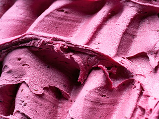 frozen black elderberry flavour gelato - full frame detail. close up of a pink surface texture of ic