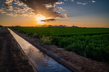 Irrigation Canal Or Water Channel In Tucson, Arizona Next To Farmland