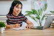 © Johnstocker - A young woman working with a laptop