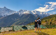Tourist couple enjoy view of Kinnaur Kailash Himalaya mountain range at Kalpa Himachal Pradesh, India	