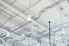 white rustic ceiling background with pipes and conduits