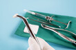  Dentistry medical tools forcept upper/ lower on blue background.